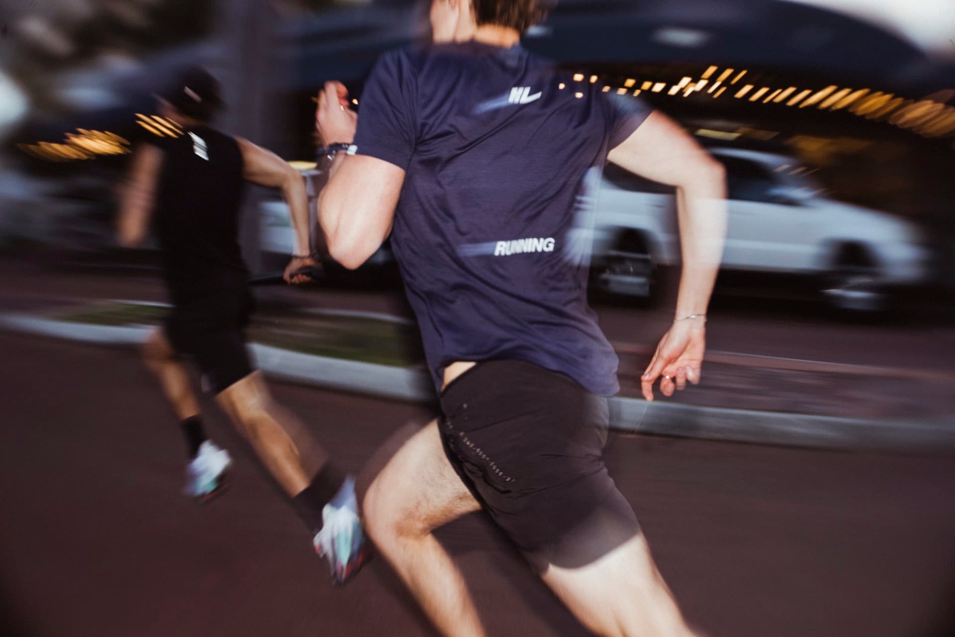 Runner racing at night during The Dash street relay in Leederville, Perth